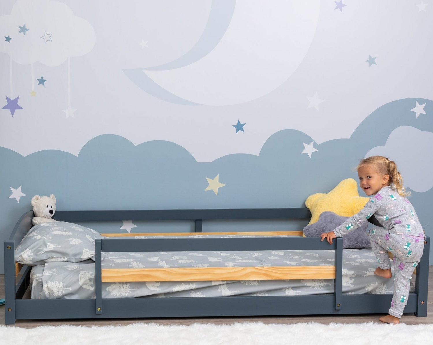 Child climbing on a floor bed with two separate entrances Montessori type