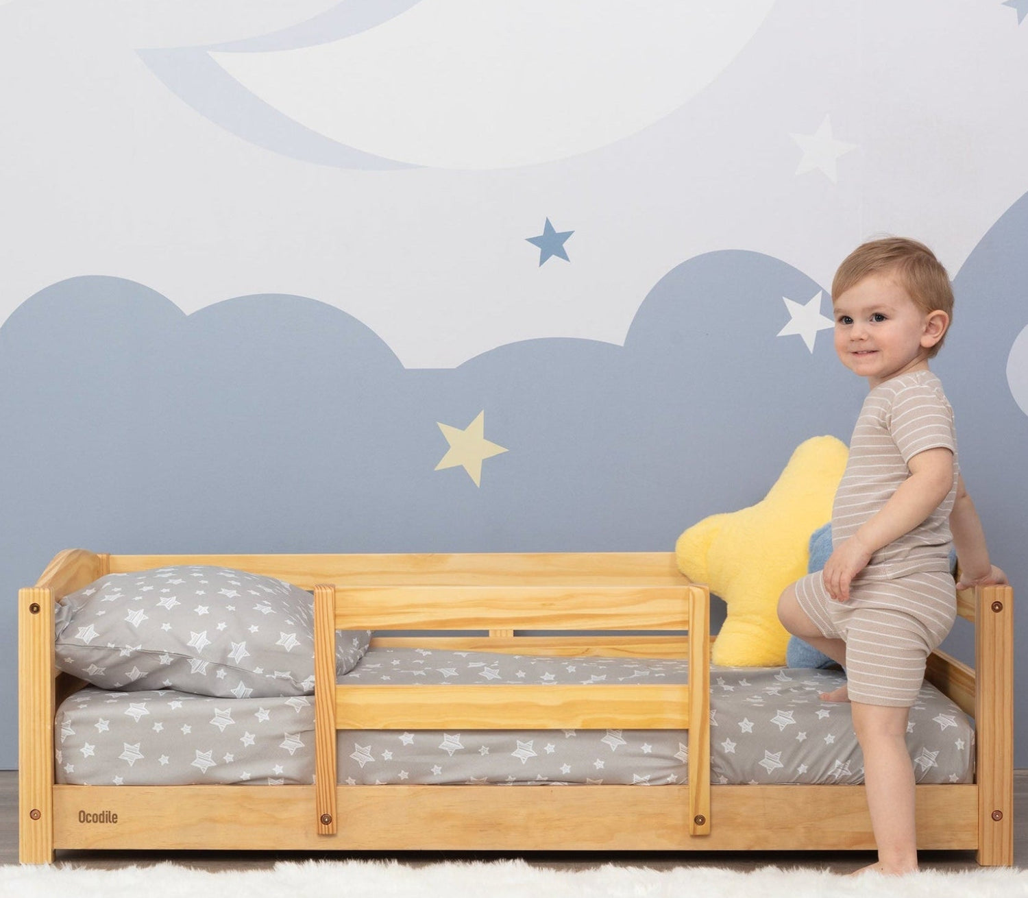 Child standing on a wooden safe floor bed design in a Montessori style